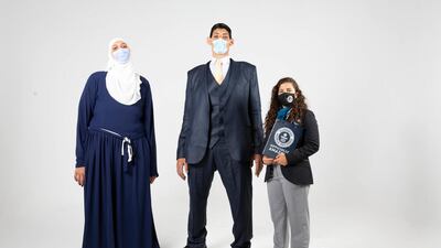 Egyptian siblings Mohamed and Huda Shehata at a Guinness World Records ceremony after breaking five records because of their gigantism. Guinness World Records Arabia