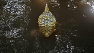 A Buddha statue almost submerged in floodwater at a temple in the central Thai province of Ayutthaya. AFP