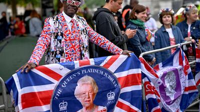 A man in costume enjoys the day outside St Paul's Cathedral before the service of thanksgiving, part of celebrations marking the queen's platinum jubilee, in London. Reuters