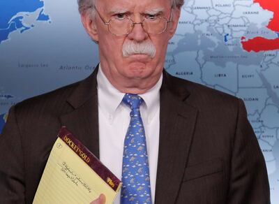 US National Security Adviser John Bolton holds a pad of note paper with a note reading '5,000 troops to Colombia'. Reuters