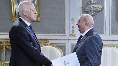 Sadok Belaid, head of Tunisia’s constitution committee, submits a draft of the new constitution to President Kais Saied at the Carthage Palace in Tunis. AFP