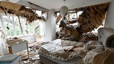 Debris is seen in a bedroom at the home of Dominic Good, a day after a 400-year-old oak tree in the garden was uprooted by Storm Eunice, in Stondon Massey, near Brentwood, Essex, England. AP