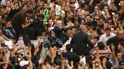 Mr Mousavi, centre right, and his wife Zahra Rahnavard, as they are surrounded by their supporters.