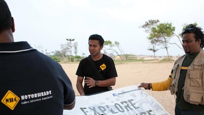 Debraj Banerjee, founder of Royal Knights Motorcycle Club setting up his club's banner at a bikers event in Mahabalipuram, Chennai.