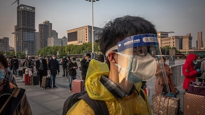 Passengers wait to enter the railway station after the lockdown was lifted, in Wuhan. EPA