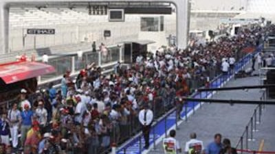 Fans pack into the pit lane during the first chance for ticket holders to see the track.