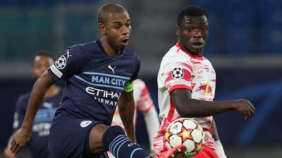 Leipzig's Dutch forward Brian Brobbey and Manchester City's Brazilian midfielder Fernandinho vie for the ball during the UEFA Champions League, Group A, match in Leipzig, eastern Germany on December 7, 2021. AFP