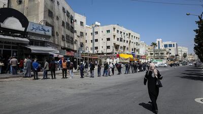 People queue to buy bread in Amman after Jordan eased restrictions on movement aimed at curbing coronavirus infections, on March 25, 2020 . Reuters
