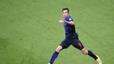 Robin van Persie celebrates his first goal against Spain on Friday night in their 2014 World Cup Group B opening match. Netherlands went down 1-0 but roared back for a 5-1 victory. Dimitar Dilkoff / AFP / June 13, 2014