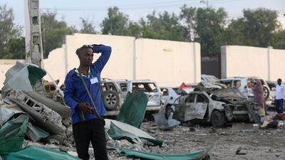 A security officer from Doorbin Hotel assesses the debris after a suicide car explosion in front of the hotel in Mogadishu, Somalia. Feisal Omar / Reuters