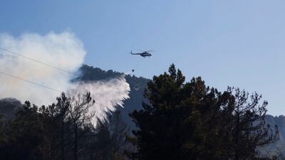 A helicopter drops water to extinguish a wildfire in Datca, Mugla province, south-west Turkey. Reuters