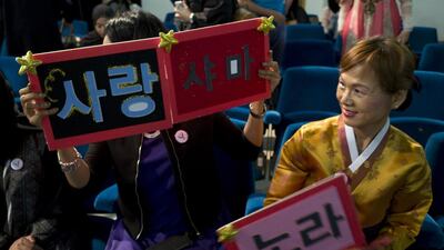 Wan Holland (right) , director of the Arab-Korean Women Society, supports some of the women participating in the Korean speech contest on Thursday night. Delores Johnson / The National