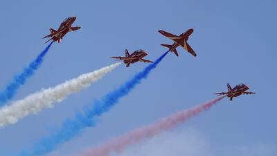 The Red Arrows team performs over RAF Odiham in Hampshire. PA