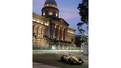 Fernando Alonso passes the Old Court House during a practice session for the Singapore Grand Prix.