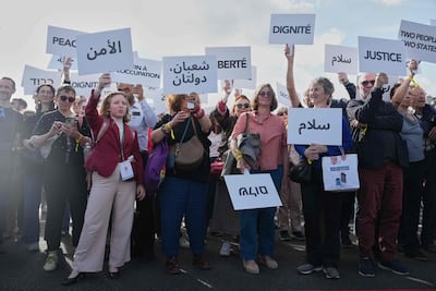 Activists held placards placards that read slogans like "peace," "freedom" and "justice" in English, Arabic, Hebrew and French on a bridge near the Notre-Dame de Paris Cathedral. AFP