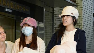 Members of Japanese female pop group AKB48 Rina Kawaei, left, and Anna Iriyama speak to the media as they are discharged from a hospital in Morioka, Iwate prefecture on May 26, 2014. A man wielding a saw slashed and injured the women at a fan event in Japan, leaving the country stunned. Reuters