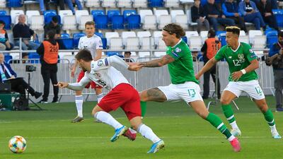 Georgia's Otar Kiteishvili, left, holds off Jeff Hendrick of Ireland. AP