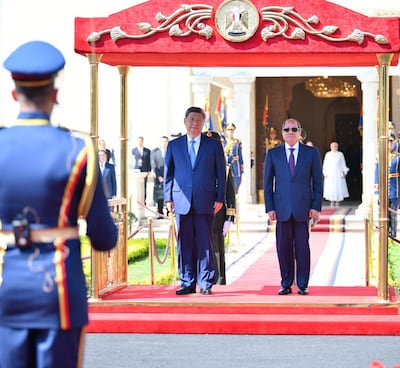 Egyptian President Abdel Fattah El Sisi and Chinese President Xi Jinping listen to their countries' national anthems at Ittihadiya Palace in Cairo. Reuters