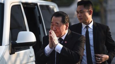 Thai business magnate and senior chairman of CP Group, Dhanin Chearavanont, arrives at the temple. AFP