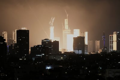 An explosion caused by a projectile strike illuminates the skyline in Tel Aviv, Israel. AP