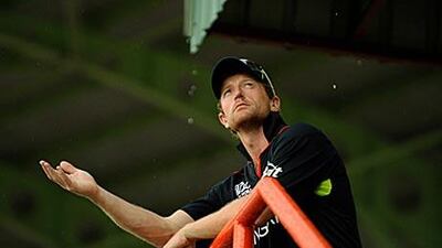 Paul Collingwood watches the rain fall during a break in the match at the Guyana National Stadium.