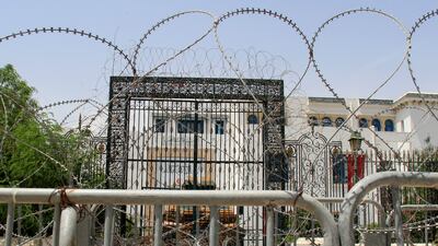Barbed wire and a military armoured personnel carrier block a side entrance of the Tunisian parliament in Tunis. AP