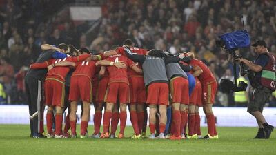 The Wales team celebrate in a huddle after their Euro 2016 qualifying win over Belgium on Friday night. Rebecca Naden / Reuters