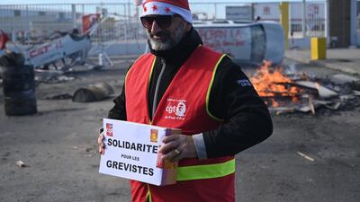 A member of the CGT trade union in France holds a box for strike fund donations on the 20th day of a nationwide multi-sector strike over French government’s plan to overhaul the country’s retirement system. AFP