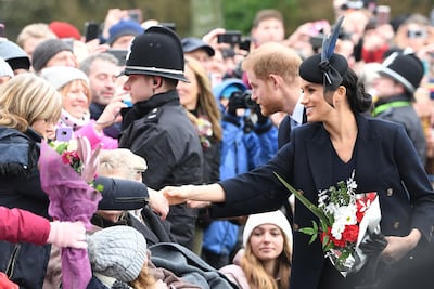 The Duchess of Sussex and Prince Harry, Duke of Sussex. greet the crowds. AFP