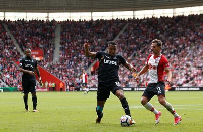 Swansea City's Martin Olsson, left,) and Southampton's Cedric Soares battle for the ball. Paul Harding / PA