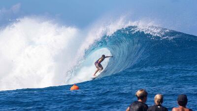 Children watch as a surfer competes. AFP
