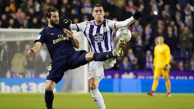Real Madrid's Spanish defender Nacho vies with Real Valladolid forward Sergi Guardiola during the Spanish La Liga match at the Jose Zorilla stadium in Valladolid. AFP