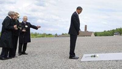 The US president pays his respects at a memorial plaque in front of the gates to the former Buchenwald Nazi camp yesterday.