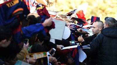 Andres Iniesta signs autographs for supporters. Toshifumi Kitamura / AFP