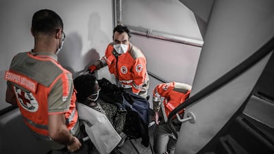 Red Cross volunteers carry a pregnant woman, as part of the Red Cross operation in Paris. AFP