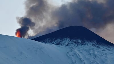 Snow-covered Mount Etna spews hot lava near Catania on Sicily. EPA