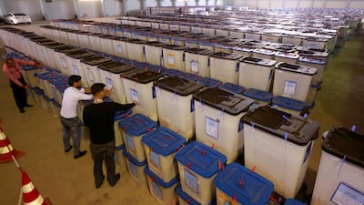 Employees of the Iraqi Independent High Electoral Commission inspect ballot boxes at a warehouse in Najaf, Iraq May 15, 2018. Alaa Al Marjani/Reuters