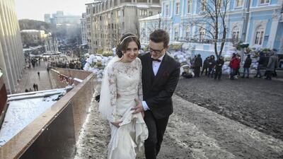 A newlywed couple walks near a barricade built by anti-government protesters in Kiev on January 26, 2014. The fate of Ukraine’s government was uncertain after embattled president Viktor Yanukovich offered opposition leaders key posts. Valentyn Ogirenko / Reuters