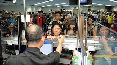 The busy immigration desk at Manila’s international airport. Filipinos will soon be able to apply for their exit certificates online. Jay Directo / AFP