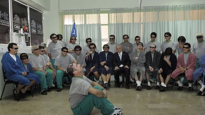 Rescued miner Mario Sepulveda acts out experiences from the time he was trapped underground in the San Jose mine, for Chile's President Sebastian Pinera at Copiapo Hosptial where the 33 rescued miners are undergoing medical examinations October 14, 2010. Chile's 33 newly rescued miners recovered from their ordeal on Thursday while also pondering the celebrity status they have gained following a more than two-month entrapment deep under a remote desert. REUTERS