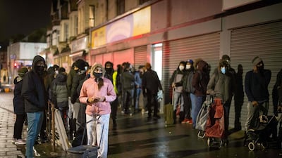 Despite the rain, dozens of young people, hoods on their heads and shopping bags in their hands, congregate in front of the small room of the Newham Community Project association, in East London. AFP