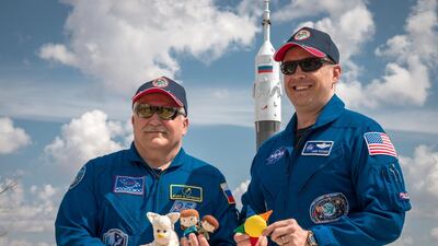 Expedition 51 crew members Fyodor Yurchikhin of Roscosmos, left, and Jack Fischer of Nasa hold up their toy mascots ahead of the April 2017 launch. Yurchikhin is holding several toys from his children and Fischer is holding an emblem of the MD Anderson Cancer Center in Houston, where his daughter, Sariah, was treated. Victor Zelentsov / Nasa