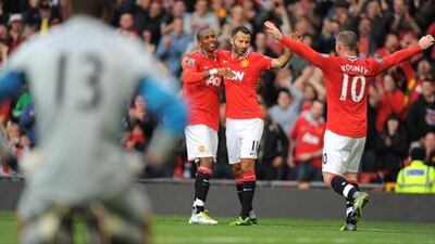 Manchester United's Ashley Young, left, celebrates with teammates, Ryan Giggs and Wayne Rooney, right, after scoring their eighth goal as they beat Arsenal 8-2 in August.