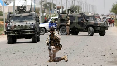 A soldier holds position as the damage is assessed after Al Shabaab hit a European Union armoured convoy in Mogadishu, Somalia. Reuters
