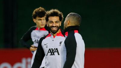 Liverpool's Mohamed Salah and Thiago Alcantara share a joke at training. Reuters