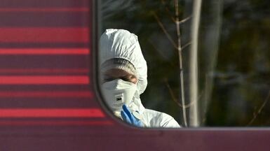 A forensic police officer examines the LNER train at Huntingdon Station in Cambridgeshire after a stabbing attack there on Saturday. Getty Images
