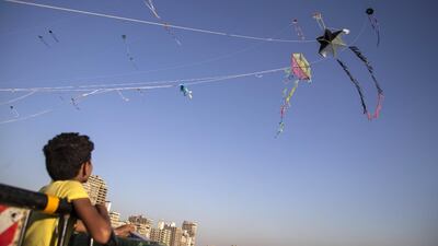 A boy prepares to fly a kite on a bridge over Nile River in Cairo, Egypt. EPA