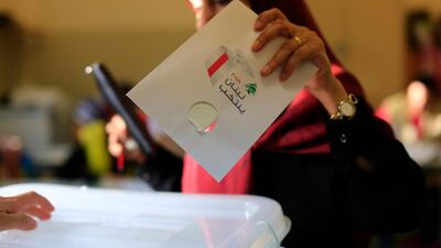 A Lebanese woman casts a ballot at a polling station during the Lebanon's parliamentary elections in a southern suburb of Beirut, Lebanon. Hassan Ammar / AP Photo