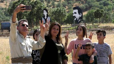 Iraqi Kurds pose for a selfie during a demonstration to protest a military operation by the Turkish army against the Kurdistan Workers' Party (PKK) in the Qandil Mountain, the PKK headquarters in northern Iraq. Safin Hamed/ AFP