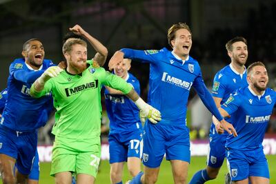 Gillingham players celebrate winning on penalties against Brentford. AP Photo